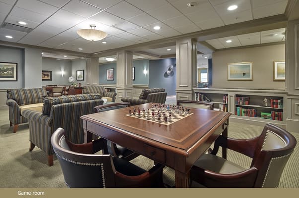 A cozy game room with chess table and seating