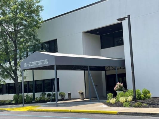 Building entrance with awning and landscaping