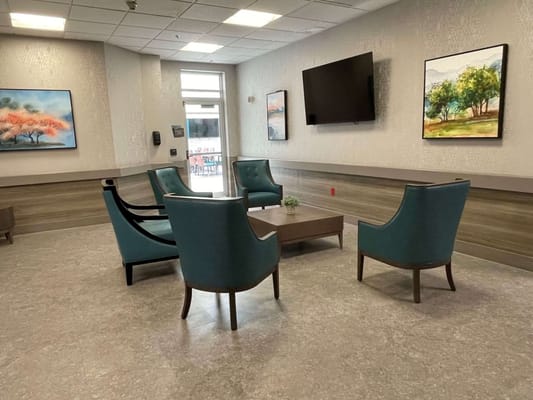 Seating area with vibrant artwork in a cozy lobby