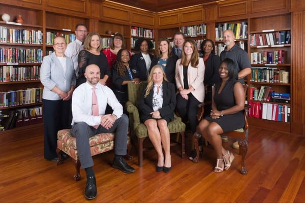 Staff group portrait in a library setting