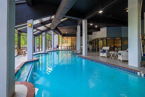 Indoor swimming pool area with lounge chairs