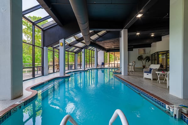 Indoor swimming pool area with large windows