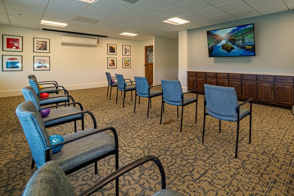 Common activity room with chairs and artwork