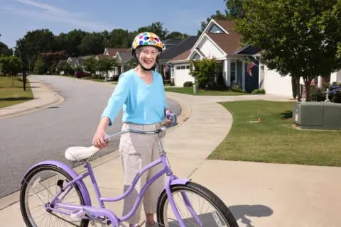 Senior woman enjoying a bike ride in a suburban neighborhood