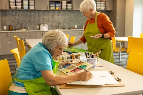 Residents enjoying a painting activity in the art studio