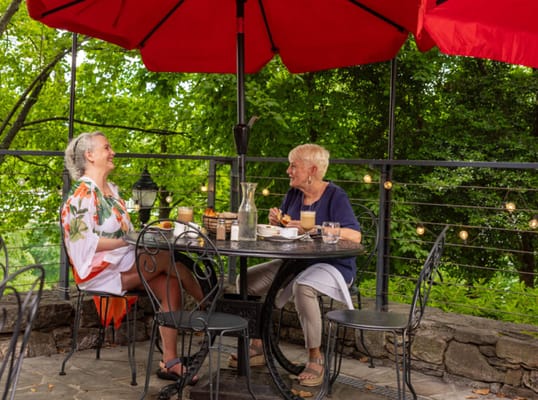 Two residents enjoying a meal on a patio