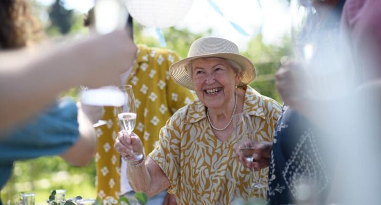 Residents enjoying a celebration outdoors with drinks