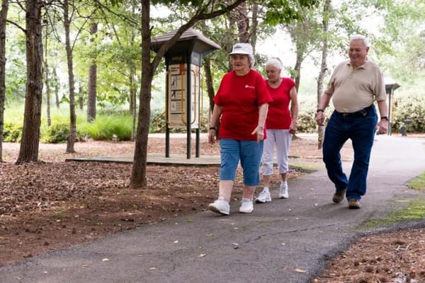 Residents walking together on a pathway in a garden
