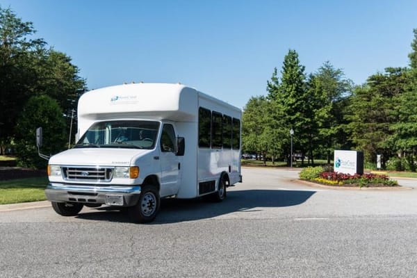 Facility shuttle bus parked near entrance