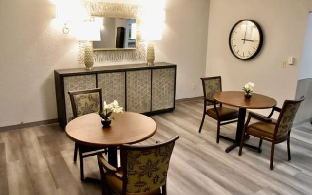 Common area with tables and chairs in a bright setting