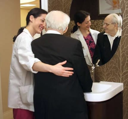Care staff assisting a resident at the sink