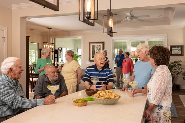 Residents enjoying drinks and conversation in a common area
