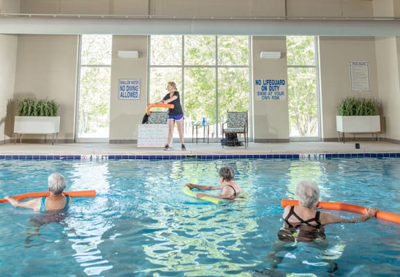 Residents participating in water exercise class in a pool
