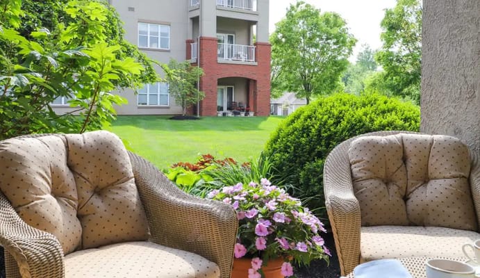 Cozy outdoor seating area with flowers and greenery