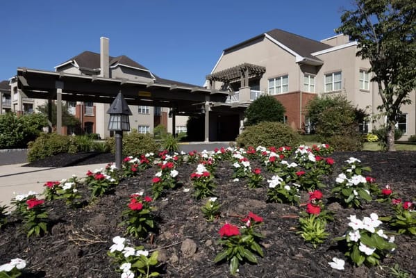 Exterior view of a senior living facility with flowers
