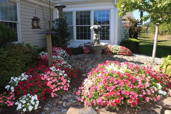 Beautiful garden area with colorful flowers and a fountain