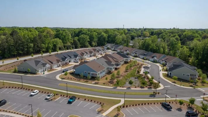 Aerial view of a senior living community with landscaped gardens