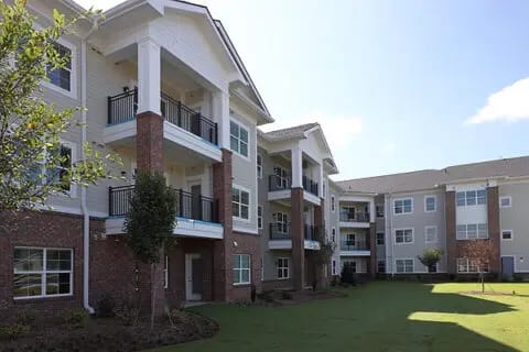 Exterior view of senior living apartments with green lawn