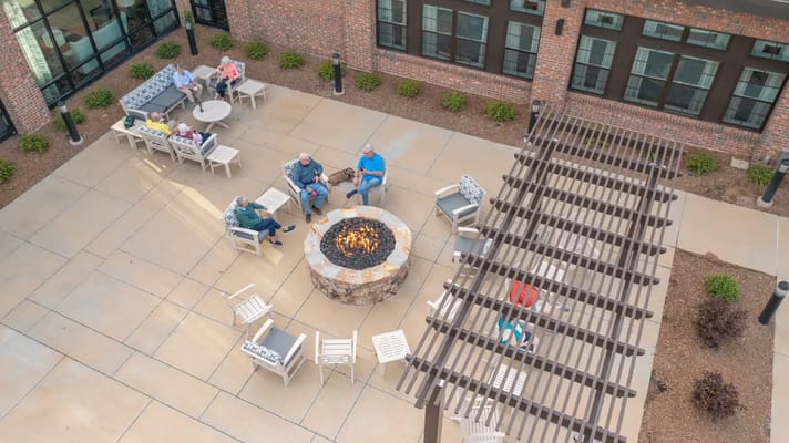 Residents enjoying an outdoor fire pit area