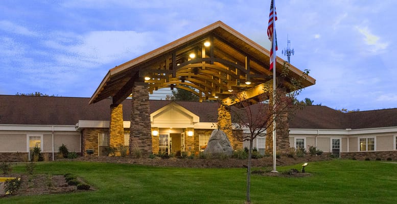 Exterior view of a senior living facility with a wooden entrance