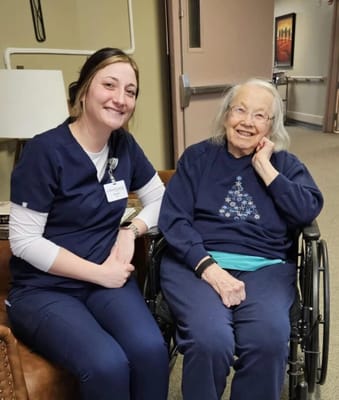 A staff member with a resident in a cozy setting