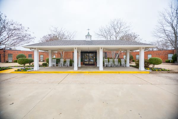Front entrance of a nursing home facility with rocking chairs