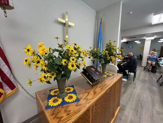 Interior common area with flowers and a cross