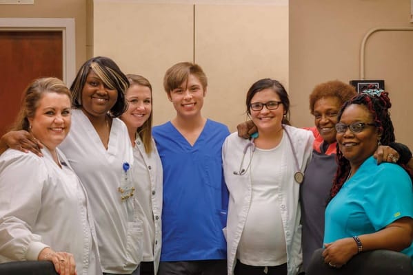Staff members posing for a group photo in the facility