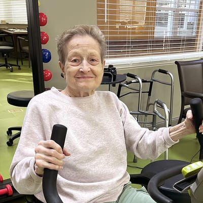 Resident engaging in exercise on fitness equipment