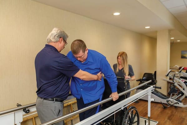 Therapist assisting a resident with rehabilitation