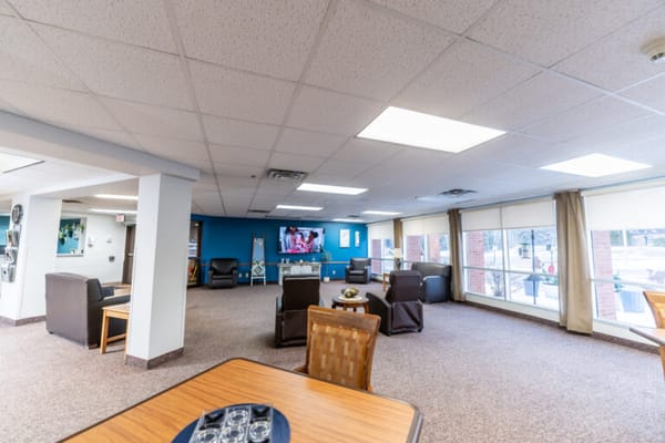 Spacious common area with seating and a television