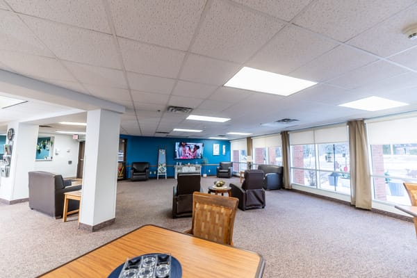 Spacious common area with seating and a television
