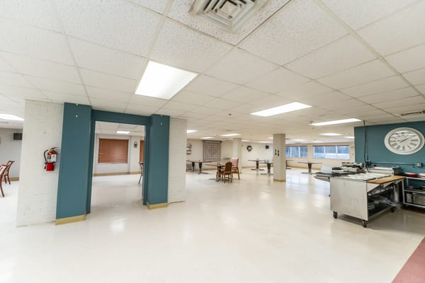 Dining area with tables and chairs in a bright setting