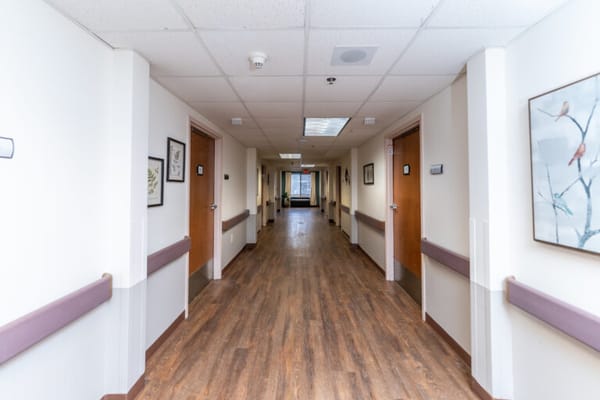 Interior hallway of a senior living facility with doors