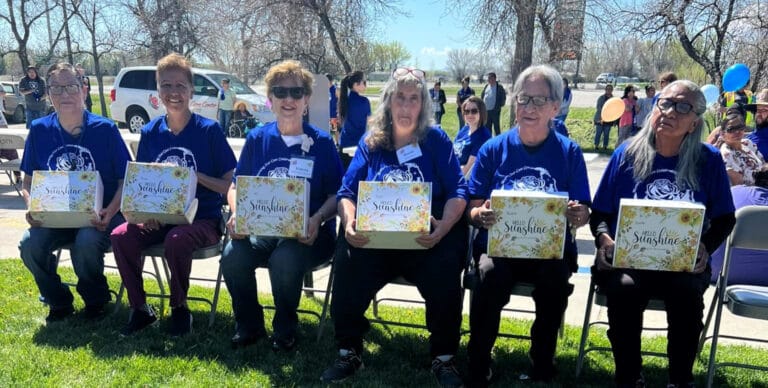 Residents celebrating outdoors with gift boxes