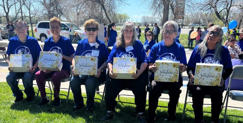 Residents celebrating outdoors with gift boxes