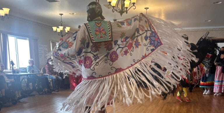 Residents enjoying a cultural performance in a common area