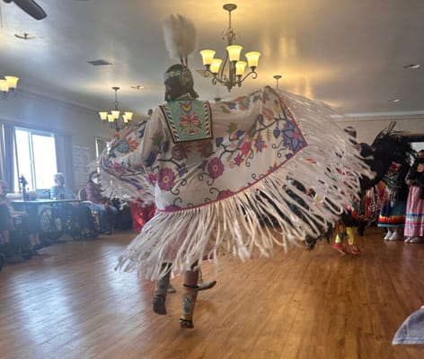 Residents enjoying a cultural dance performance in a common area