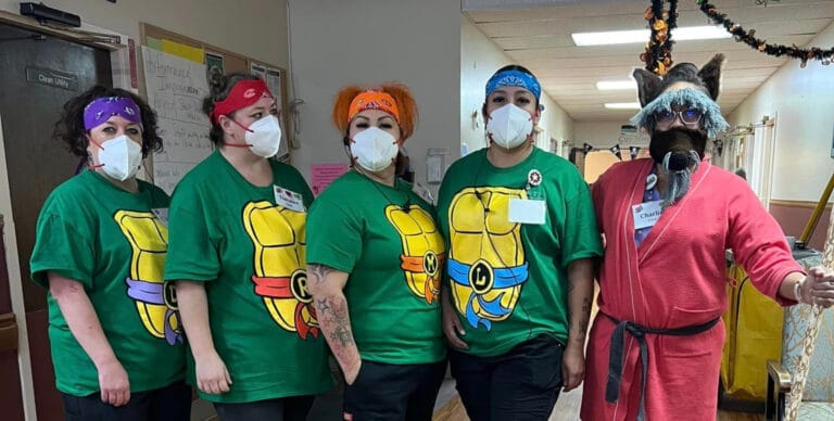 Staff members in themed costumes celebrating