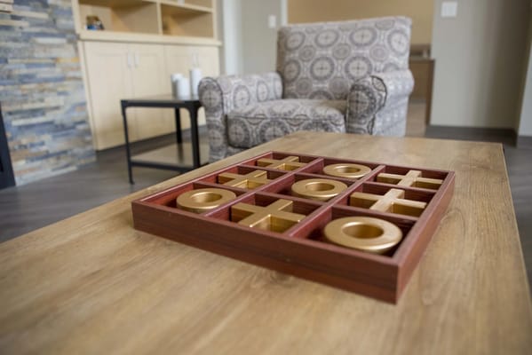 Tic-tac-toe game on a coffee table in a common area