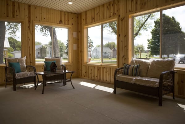 Bright sunroom with comfortable seating and large windows
