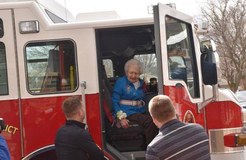 A resident enjoying a special visit in a fire truck