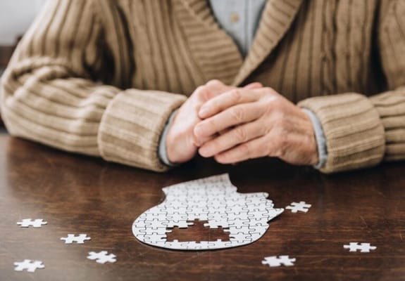 A resident working on a puzzle at a table
