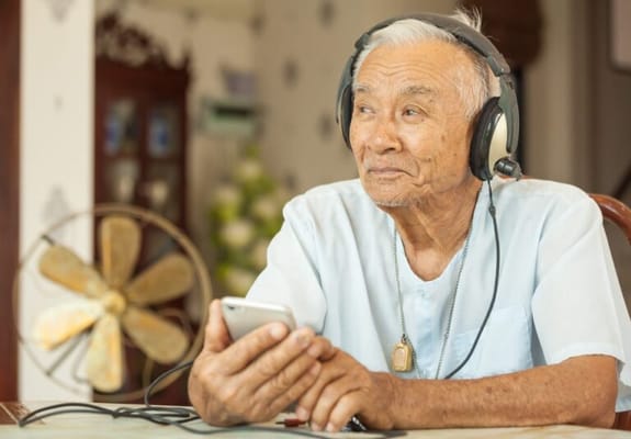 Senior man enjoying music with headphones