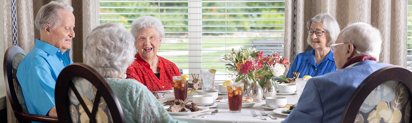 Seniors enjoying a meal together in a dining area