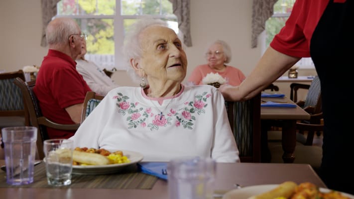 Residents enjoying a meal in a dining room