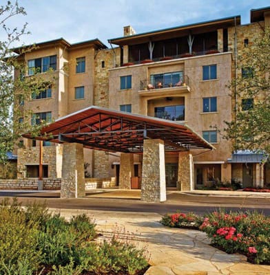 Exterior view of a senior living facility with landscaping