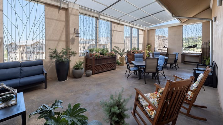Outdoor patio area with seating and greenery