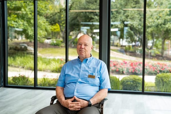 A staff member seated in a bright common area