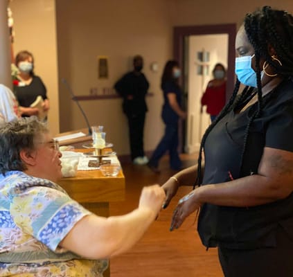 Staff assisting a resident in a common area